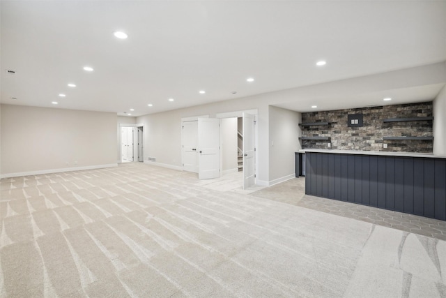 17829 Valley View Dr, Clive, IA 50325 - finished below grade area featuring light colored carpet, wet bar, recessed lighting, and baseboards