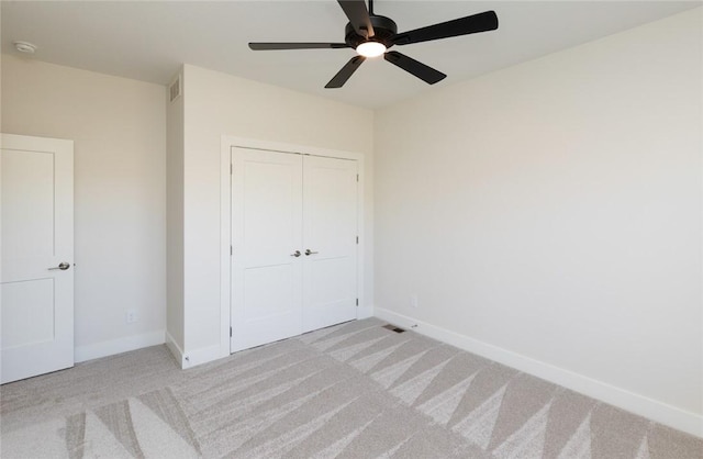 733 17th Ave SE, Altoona, IA 50009 - unfurnished bedroom with carpet, a closet, and a ceiling fan
