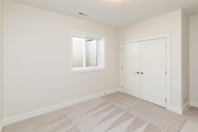 733 17th Ave SE, Altoona, IA 50009 - unfurnished bedroom with light colored carpet and a closet