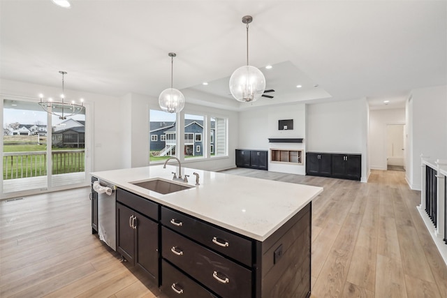 17865 Valley View Dr, Clive, IA 50325 - kitchen featuring a sink, dishwasher, light wood-type flooring, a tray ceiling, and recessed lighting