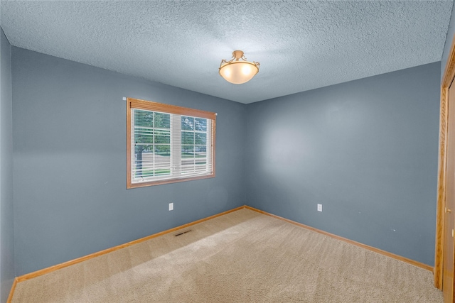 810 NE 5th St, Ankeny, IA 50021 - carpeted spare room with baseboards and a textured ceiling