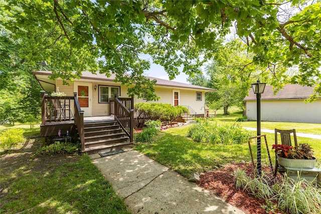 403 S Elm St, Lamoni, IA 50140 - ranch-style home featuring a front lawn and a wooden deck