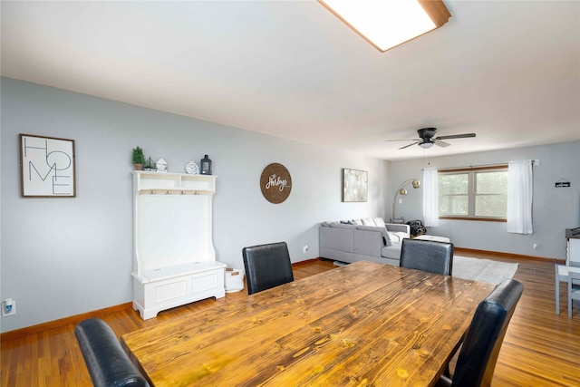 403 S Elm St, Lamoni, IA 50140 - dining space with ceiling fan, baseboards, and light wood-style floors