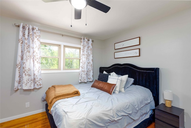 403 S Elm St, Lamoni, IA 50140 - bedroom featuring wood finished floors, baseboards, and a ceiling fan