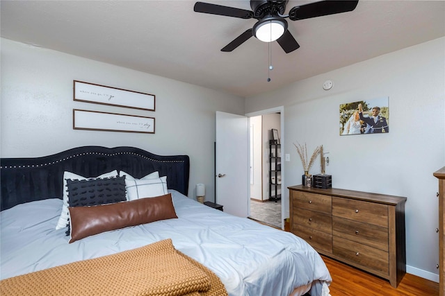 403 S Elm St, Lamoni, IA 50140 - bedroom with wood finished floors, baseboards, and ceiling fan