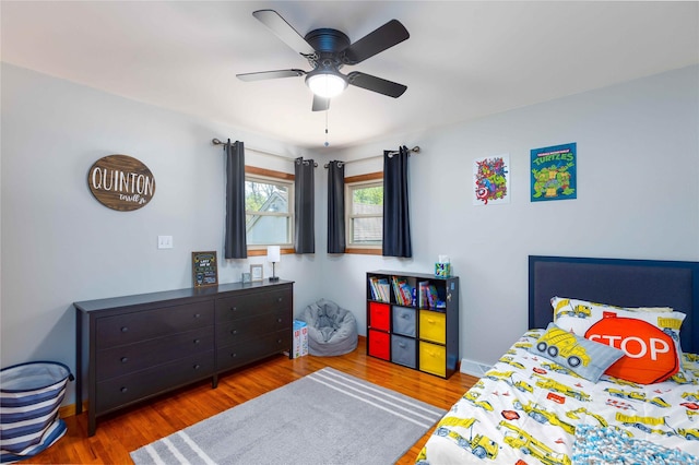 403 S Elm St, Lamoni, IA 50140 - bedroom featuring wood finished floors, baseboards, and a ceiling fan
