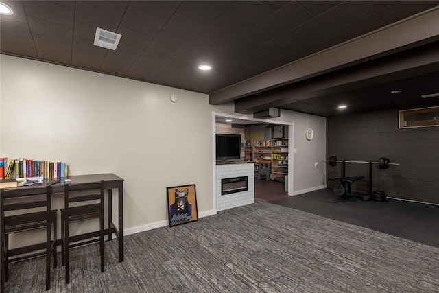 403 S Elm St, Lamoni, IA 50140 - finished basement featuring a glass covered fireplace, carpet, baseboards, and recessed lighting