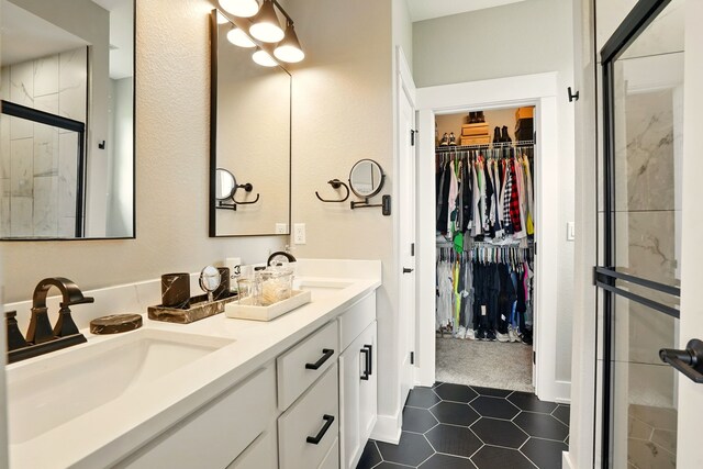 1108 NE Forest Ridge Ct, Ankeny, IA 50021 - full bathroom featuring a spacious closet, a shower stall, double vanity, and tile patterned flooring