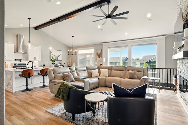 1108 NE Forest Ridge Ct, Ankeny, IA 50021 - living room featuring ceiling fan, beamed ceiling, light wood-style floors, a fireplace, and high vaulted ceiling