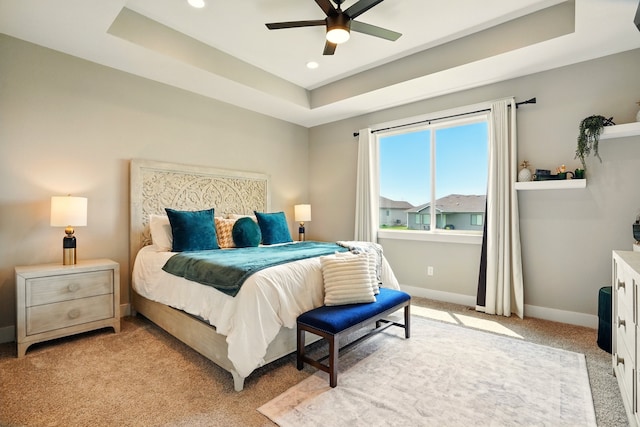 1108 NE Forest Ridge Ct, Ankeny, IA 50021 - bedroom featuring light carpet, a tray ceiling, baseboards, recessed lighting, and ceiling fan