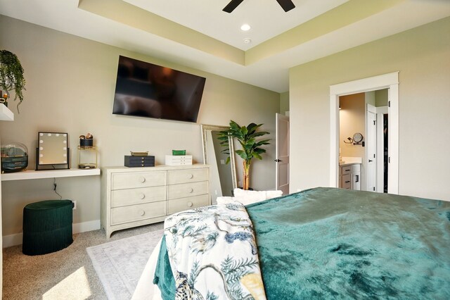 1108 NE Forest Ridge Ct, Ankeny, IA 50021 - carpeted bedroom with a tray ceiling, baseboards, and a ceiling fan
