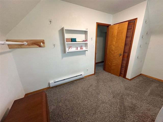 702 N 2nd Ave, Winterset, IA 50273 - unfurnished bedroom featuring a baseboard radiator, carpet floors, a closet, and baseboards