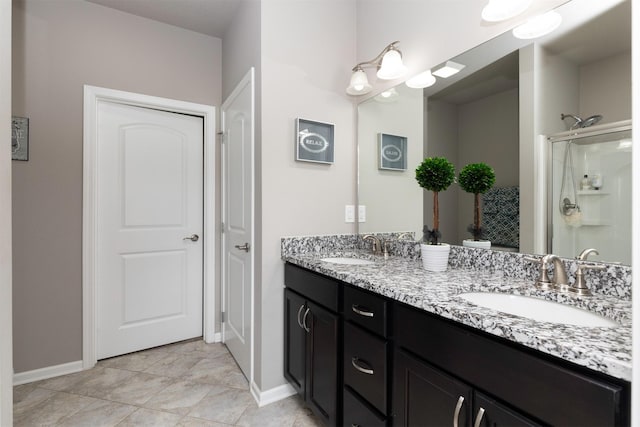 1245 Blue Bonnet Dr, Carlisle, IA 50047 - bathroom with double vanity, baseboards, and an enclosed shower
