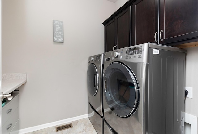 1245 Blue Bonnet Dr, Carlisle, IA 50047 - washroom featuring cabinet space, washing machine and dryer, baseboards, and light tile patterned floors