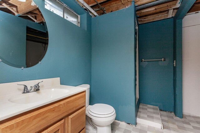 706 S Buxton St, Indianola, IA 50125 - bathroom featuring toilet, tile patterned floors, and vanity