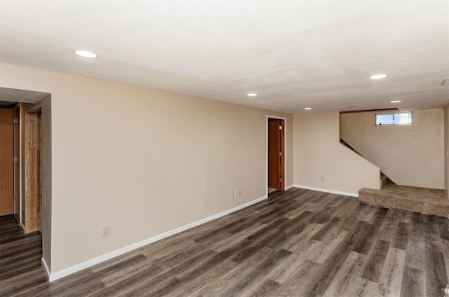 706 S Buxton St, Indianola, IA 50125 - below grade area featuring dark wood-type flooring, recessed lighting, baseboards, and stairs