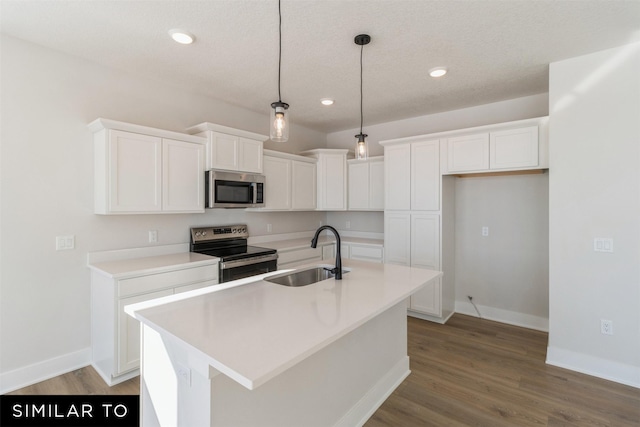 4208 NE 5th St, Ankeny, IA 50021 - kitchen featuring stainless steel appliances, a sink, white cabinets, pendant lighting, and an island with sink