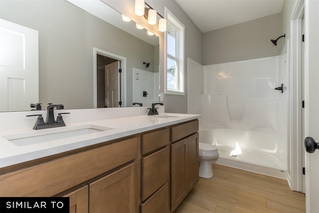 4212 NE 5th St, Ankeny, IA 50021 - bathroom with toilet, double vanity, wood finished floors, and a shower