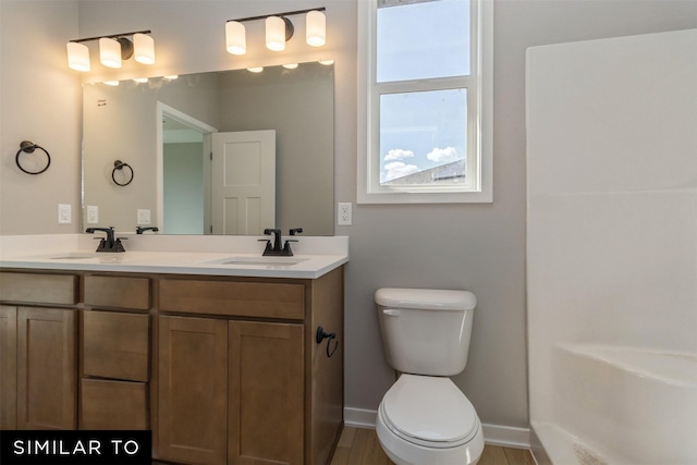 4212 NE 5th St, Ankeny, IA 50021 - full bathroom featuring double vanity, toilet, and baseboards
