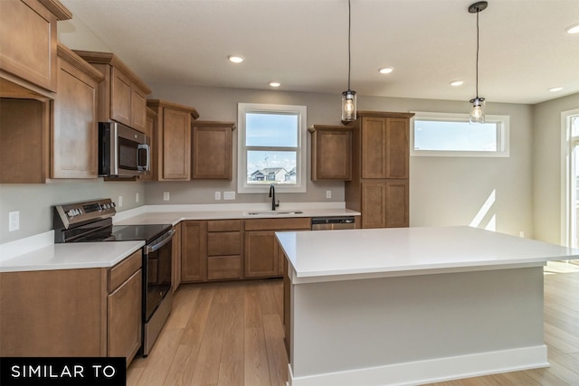 4212 NE 5th St, Ankeny, IA 50021 - kitchen with appliances with stainless steel finishes, a sink, light wood-type flooring, brown cabinets, and recessed lighting