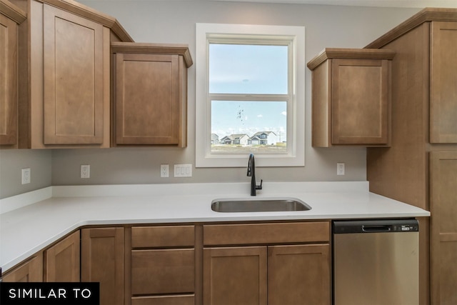 4212 NE 5th St, Ankeny, IA 50021 - kitchen with dishwasher, a sink, light countertops, and brown cabinetry