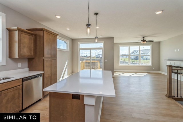 4212 NE 5th St, Ankeny, IA 50021 - kitchen featuring stainless steel dishwasher, light wood-style flooring, a center island, light countertops, and open floor plan