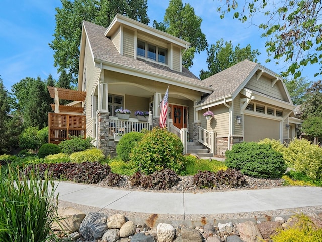 15075 Sheridan Ave, Clive, IA 50325 - view of front of property featuring stone siding, a porch, and a shingled roof
