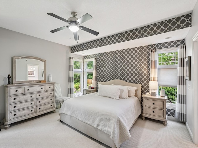 15075 Sheridan Ave, Clive, IA 50325 - bedroom featuring light colored carpet, a ceiling fan, an accent wall, baseboards, and wallpapered walls