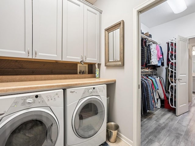 15075 Sheridan Ave, Clive, IA 50325 - laundry room with independent washer and dryer, cabinet space, light wood-style floors, and baseboards