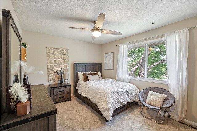 2501 SE 18th Ct, Des Moines, IA 50320 - bedroom with light colored carpet, a textured ceiling, and a ceiling fan