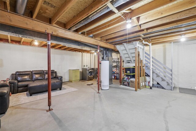2501 SE 18th Ct, Des Moines, IA 50320 - unfinished basement featuring washer and clothes dryer, gas water heater, and stairway