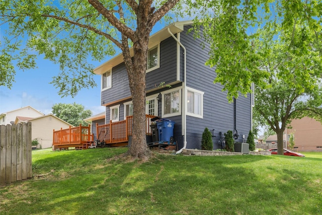 2501 SE 18th Ct, Des Moines, IA 50320 - back of house with a deck, a yard, and central AC