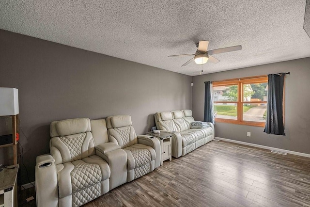 1863 Glenwood Cir, Des Moines, IA 50320 - living room featuring ceiling fan, wood finished floors, baseboards, and a textured ceiling