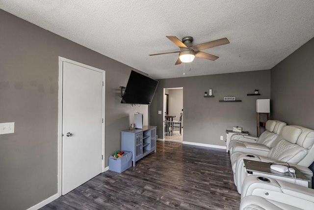 1863 Glenwood Cir, Des Moines, IA 50320 - living room featuring a ceiling fan, dark wood-style flooring, baseboards, and a textured ceiling