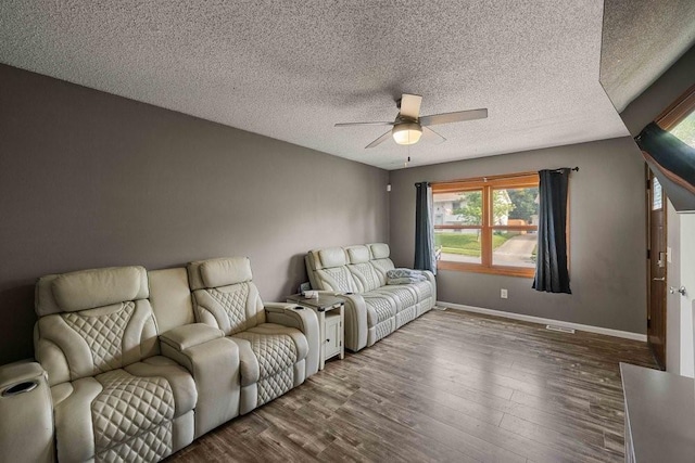 1863 Glenwood Cir, Des Moines, IA 50320 - living room featuring ceiling fan, wood finished floors, baseboards, and a textured ceiling
