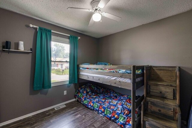 1863 Glenwood Cir, Des Moines, IA 50320 - bedroom with a textured ceiling, wood finished floors, baseboards, and ceiling fan
