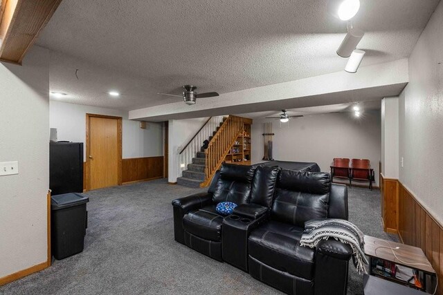 1863 Glenwood Cir, Des Moines, IA 50320 - carpeted cinema with wood walls, a ceiling fan, a wainscoted wall, and a textured ceiling