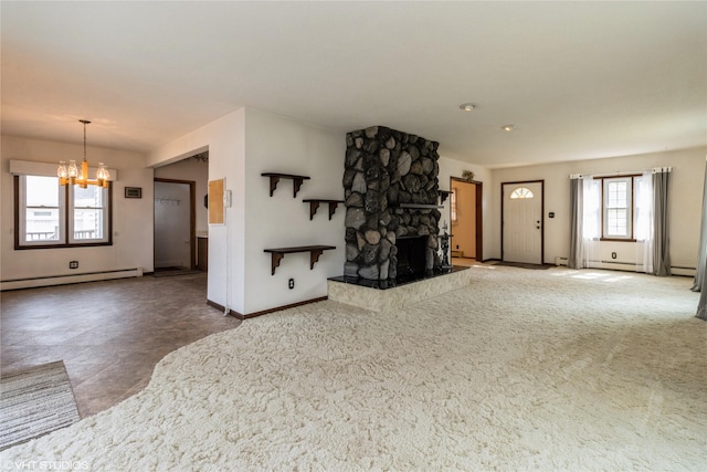 1723 6th St, Perry, IA 50220 - unfurnished living room featuring a chandelier, baseboard heating, baseboards, and a stone fireplace