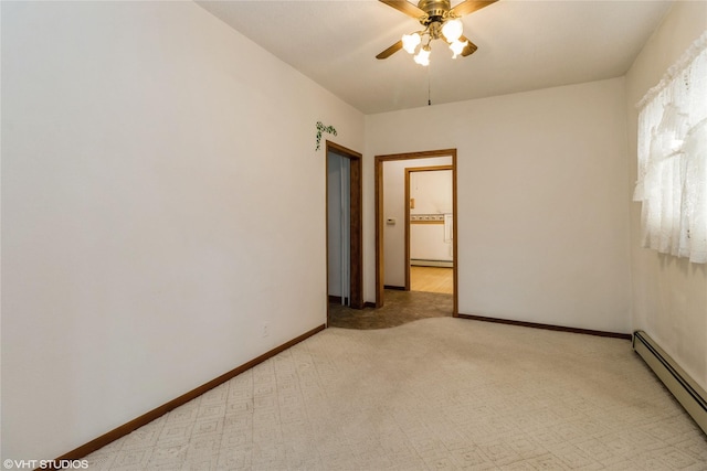 1723 6th St, Perry, IA 50220 - empty room featuring a baseboard radiator, light carpet, ceiling fan, baseboards, and a baseboard heating unit