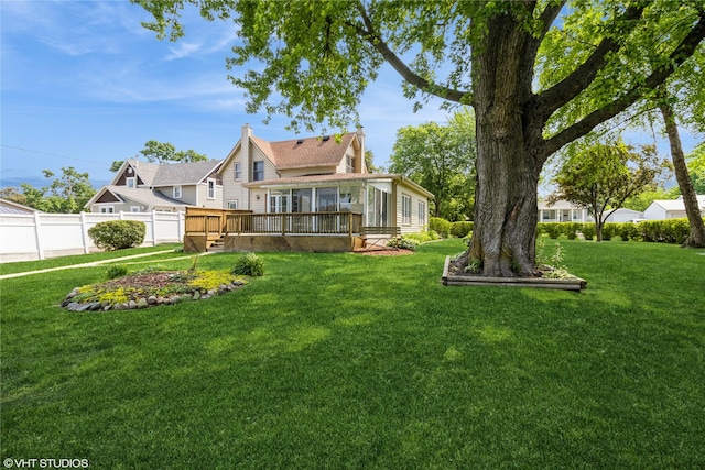 1723 6th St, Perry, IA 50220 - view of yard featuring a sunroom and a wooden deck
