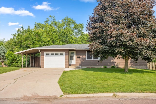 817 Roberts Ter, Marshalltown, IA 50158 - view of front of home featuring driveway, a front lawn, an attached garage, and an attached carport
