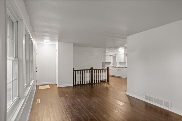 817 Roberts Ter, Marshalltown, IA 50158 - empty room featuring wood finished floors, baseboards, and a sink