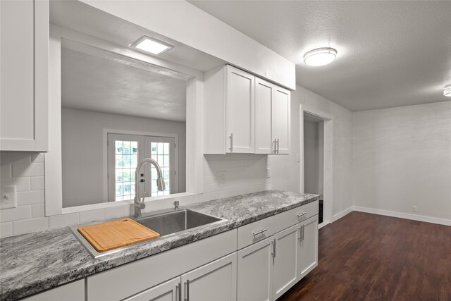 817 Roberts Ter, Marshalltown, IA 50158 - kitchen with a sink, dark wood finished floors, white cabinetry, and baseboards