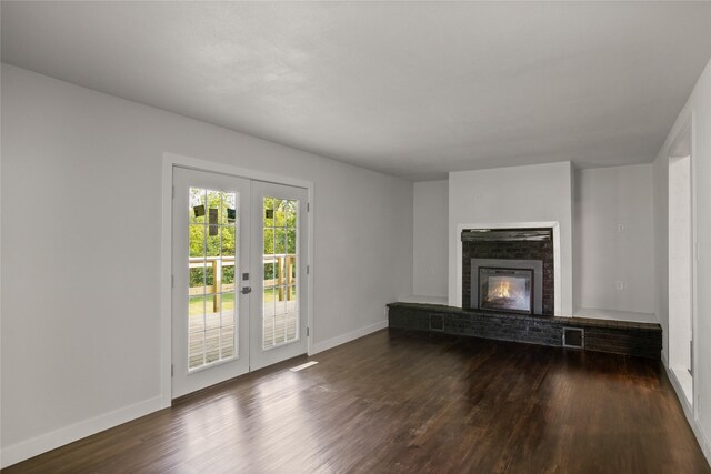 817 Roberts Ter, Marshalltown, IA 50158 - unfurnished living room featuring french doors, dark wood-type flooring, baseboards, and a fireplace