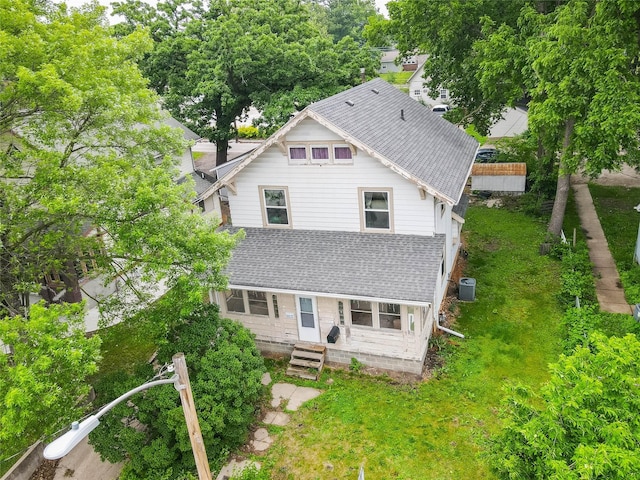 3417 6th Ave, Des Moines, IA 50313 - back of house featuring roof with shingles, central AC unit, entry steps, and a yard