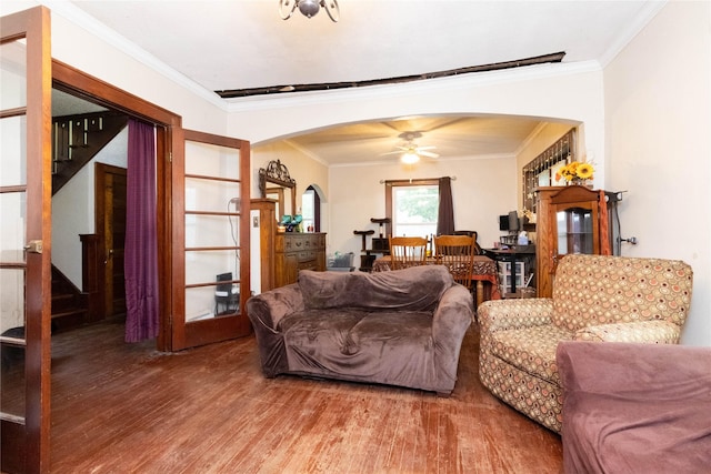 3417 6th Ave, Des Moines, IA 50313 - living room featuring arched walkways, crown molding, wood finished floors, ceiling fan, and stairs