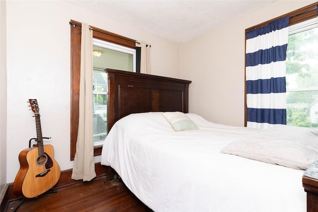3417 6th Ave, Des Moines, IA 50313 - bedroom featuring dark wood-style flooring and multiple windows