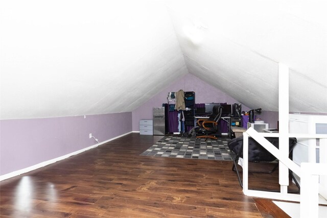 3417 6th Ave, Des Moines, IA 50313 - additional living space featuring lofted ceiling, a desk, wood finished floors, and baseboards