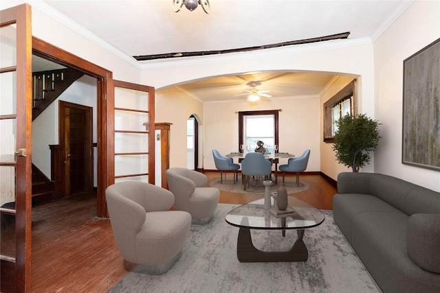 3417 6th Ave, Des Moines, IA 50313 - living room with wood finished floors, arched walkways, crown molding, stairway, and a ceiling fan