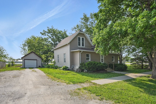 417 NE 2nd St, Panora, IA 50216 - view of front of house with an outdoor structure, a front yard, and a garage
